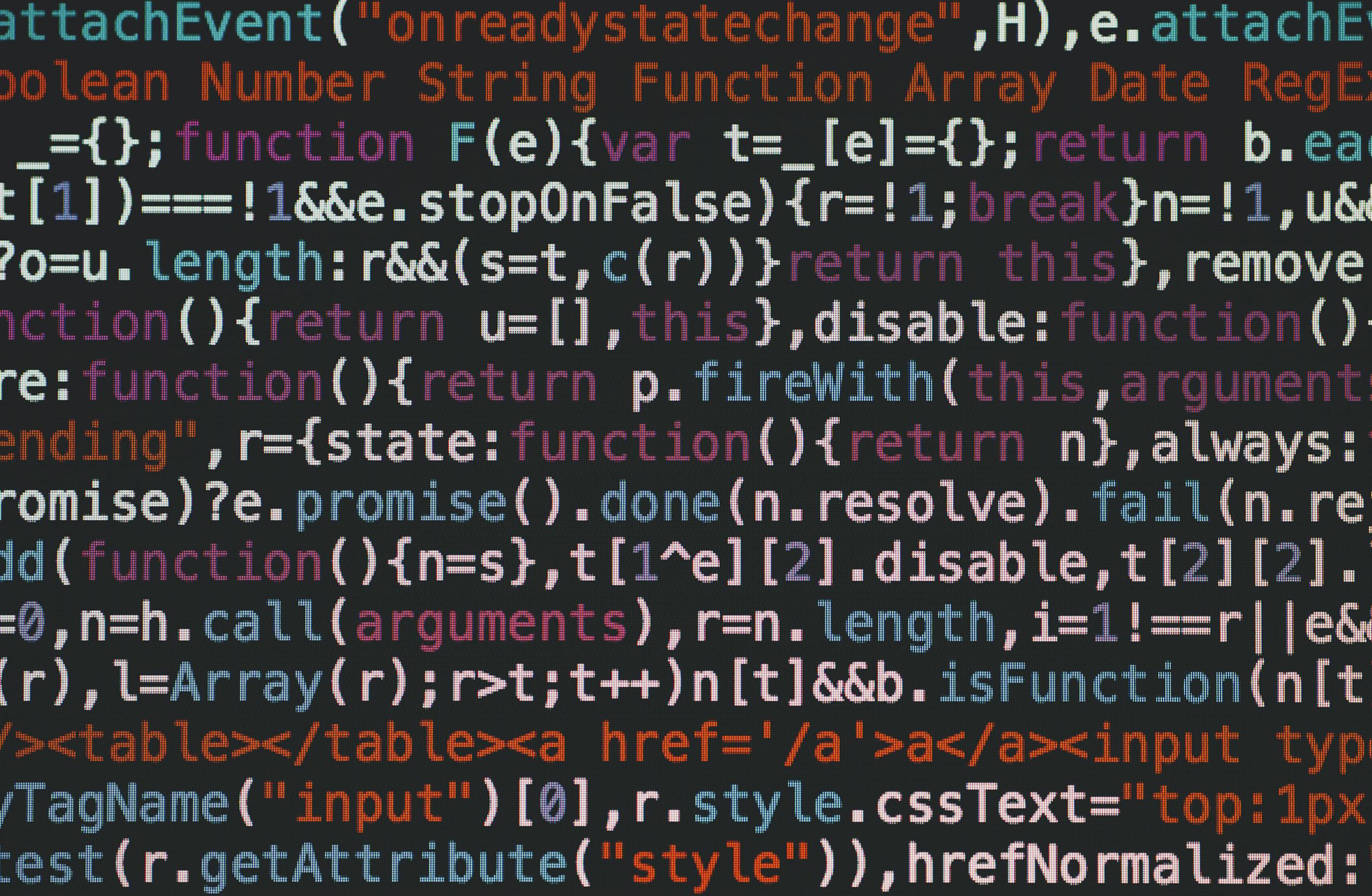 Close-up of colorful coding text on a dark computer screen, representing software development.
